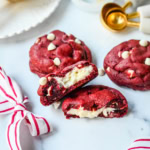 Cheesecake stuffed Red Velvet Cookies with white chocolate chips and a creamy cheesecake center are the perfect Christmas cookie. A vibrant red velvet cookie meets a creamy cheesecake center, with bursts of sweetness from white chocolate chips in every bite.