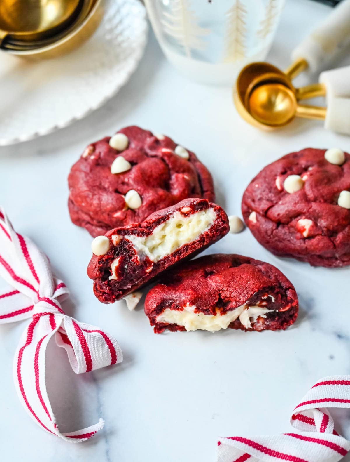 Cheesecake stuffed Red Velvet Cookies with white chocolate chips and a creamy cheesecake center are the perfect Christmas cookie. A vibrant red velvet cookie meets a creamy cheesecake center, with bursts of sweetness from white chocolate chips in every bite. 