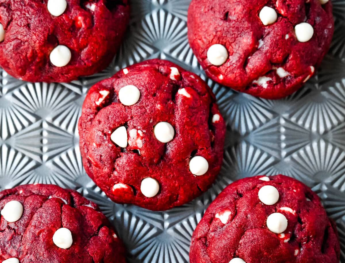 Cheesecake filled red velvet cookies on a baking sheet