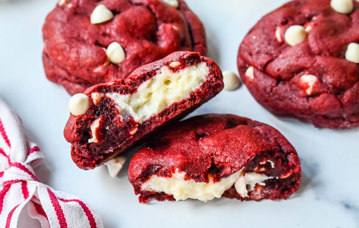 Cheesecake stuffed Red Velvet Cookies with white chocolate chips and a creamy cheesecake center are the perfect Christmas cookie. A vibrant red velvet cookie meets a creamy cheesecake center, with bursts of sweetness from white chocolate chips in every bite.