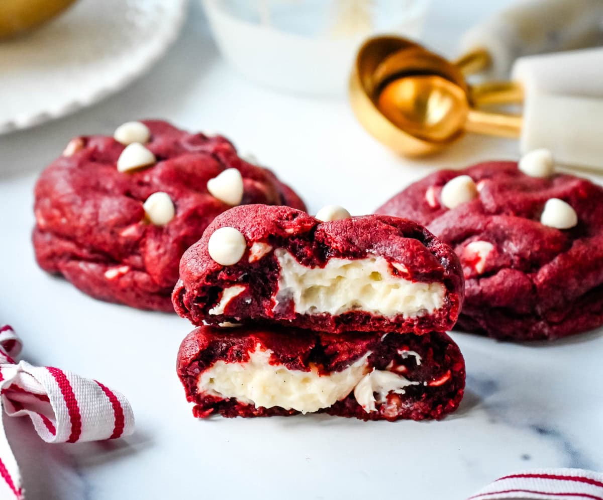 Cheesecake stuffed Red Velvet Cookies with white chocolate chips and a creamy cheesecake center are the perfect Christmas cookie. A vibrant red velvet cookie meets a creamy cheesecake center, with bursts of sweetness from white chocolate chips in every bite. 