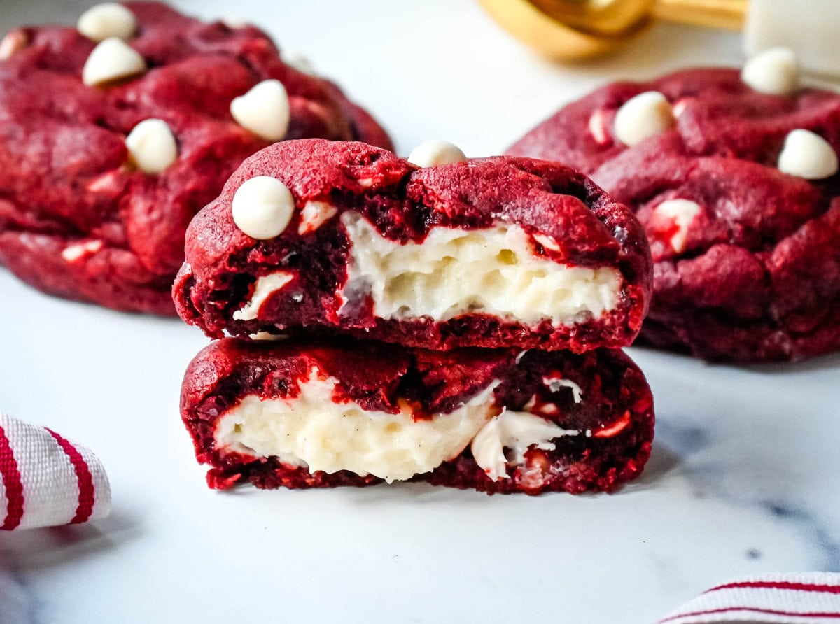 Cheesecake stuffed Red Velvet Cookies with white chocolate chips and a creamy cheesecake center are the perfect Christmas cookie. A vibrant red velvet cookie meets a creamy cheesecake center, with bursts of sweetness from white chocolate chips in every bite.