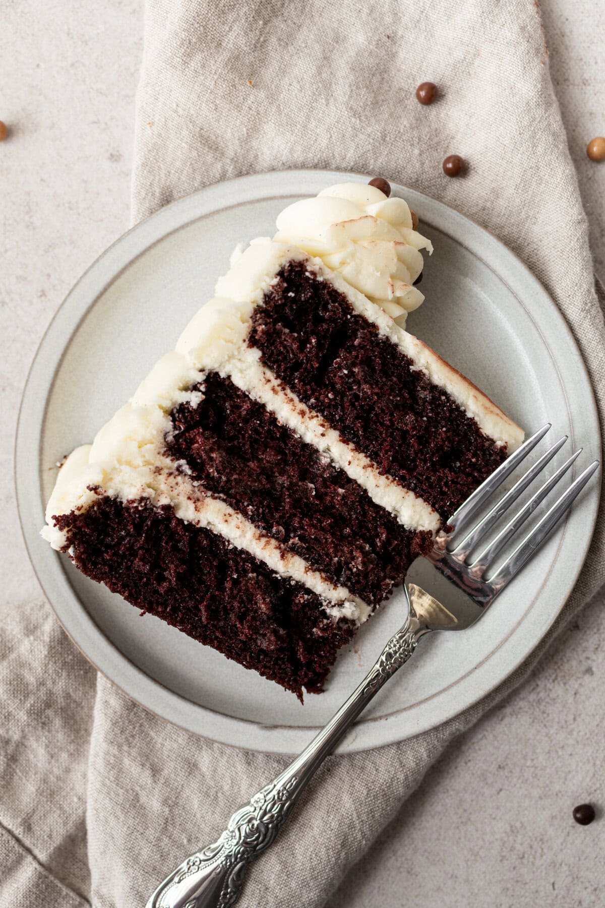 Rich, moist homemade chocolate cake with a creamy vanilla frosting. This decadent chocolate cake with vanilla frosting is a moist, rich chocolate cake covered in a smooth, sweet vanilla buttercream. Sometimes known as a chocolate layer cake with white icing or a chocolate birthday cake with vanilla buttercream, it’s perfect for any celebration. The perfect Black and White Cake!