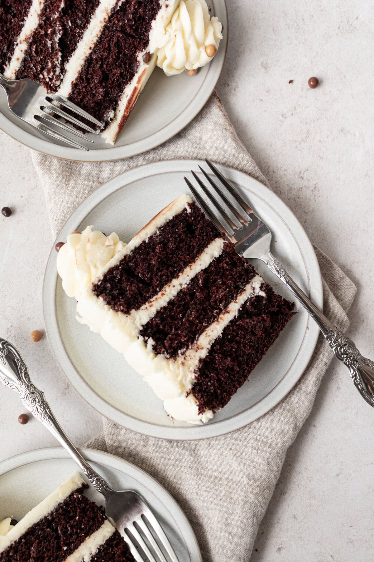 Rich, moist homemade chocolate cake with a creamy vanilla frosting. This decadent chocolate cake with vanilla frosting is a moist, rich chocolate cake covered in a smooth, sweet vanilla buttercream. Sometimes known as a chocolate layer cake with white icing or a chocolate birthday cake with vanilla buttercream, it’s perfect for any celebration. The perfect Black and White Cake!