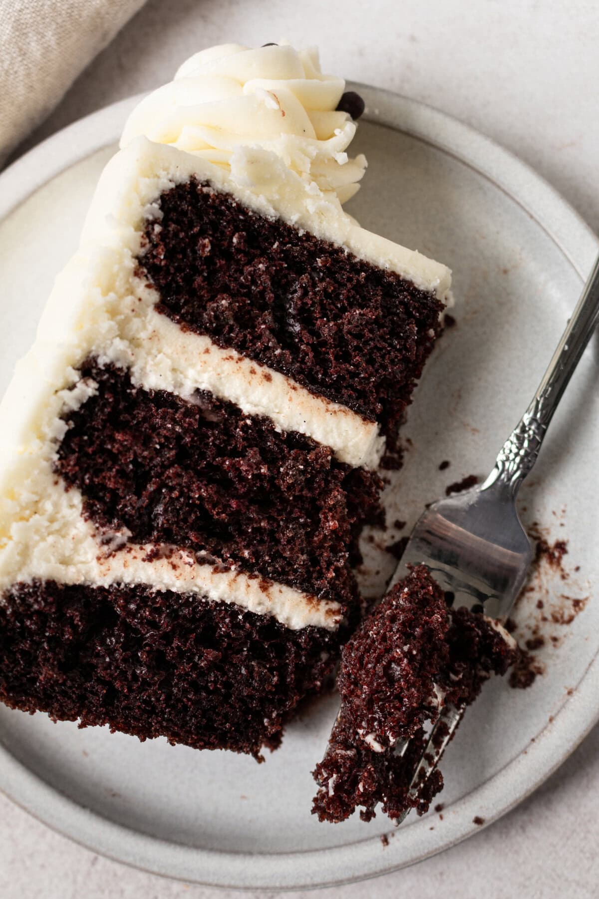 Rich, moist homemade chocolate cake with a creamy vanilla frosting. This decadent chocolate cake with vanilla frosting is a moist, rich chocolate cake covered in a smooth, sweet vanilla buttercream. Sometimes known as a chocolate layer cake with white icing or a chocolate birthday cake with vanilla buttercream, it’s perfect for any celebration. The perfect Black and White Cake!