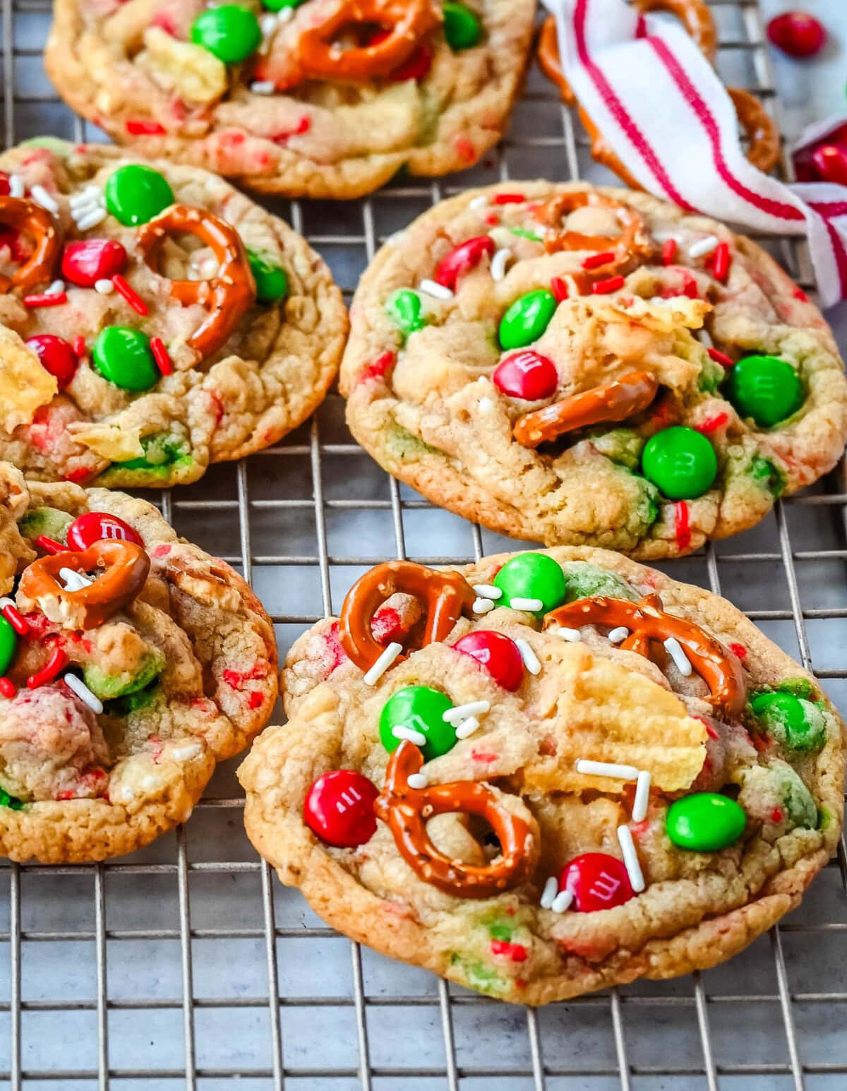 Get ready to bake the ultimate Christmas treat with these Christmas Kitchen Sink Cookies! Packed with holiday M&M's, pretzels, potato chips, sprinkles, and optional chocolate chips, these cookies bring together sweet, salty, and festive flavors in every bite. They're easy to make, fun to customize, and perfect for gifting, cookie swaps, and for your Christmas baking.