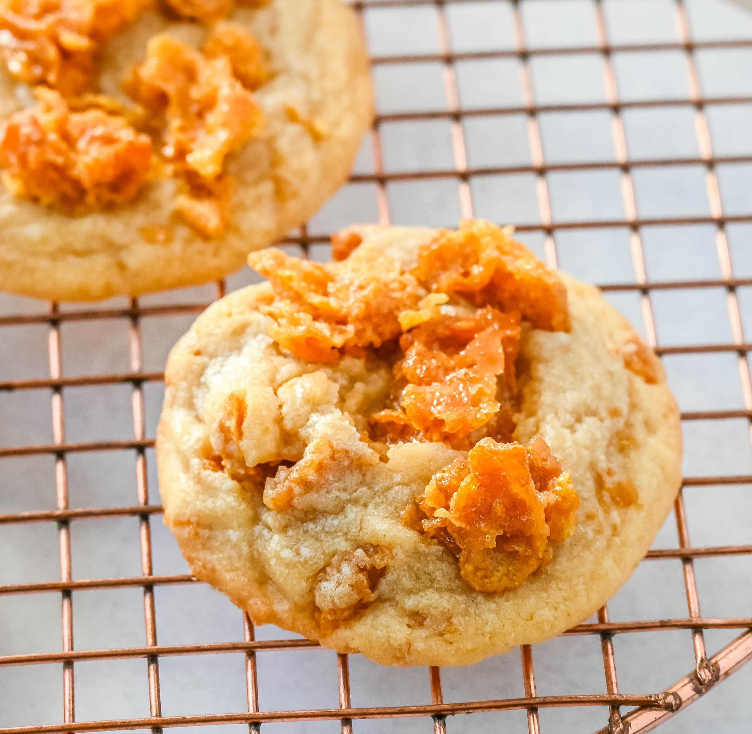 These Cornflake Crack Cookies are buttery, chewy, crispy cookies with toffee caramel notes thanks to homemade cornflake crack in and on top of the cookies. These sweet and salty cookies are always a hit!