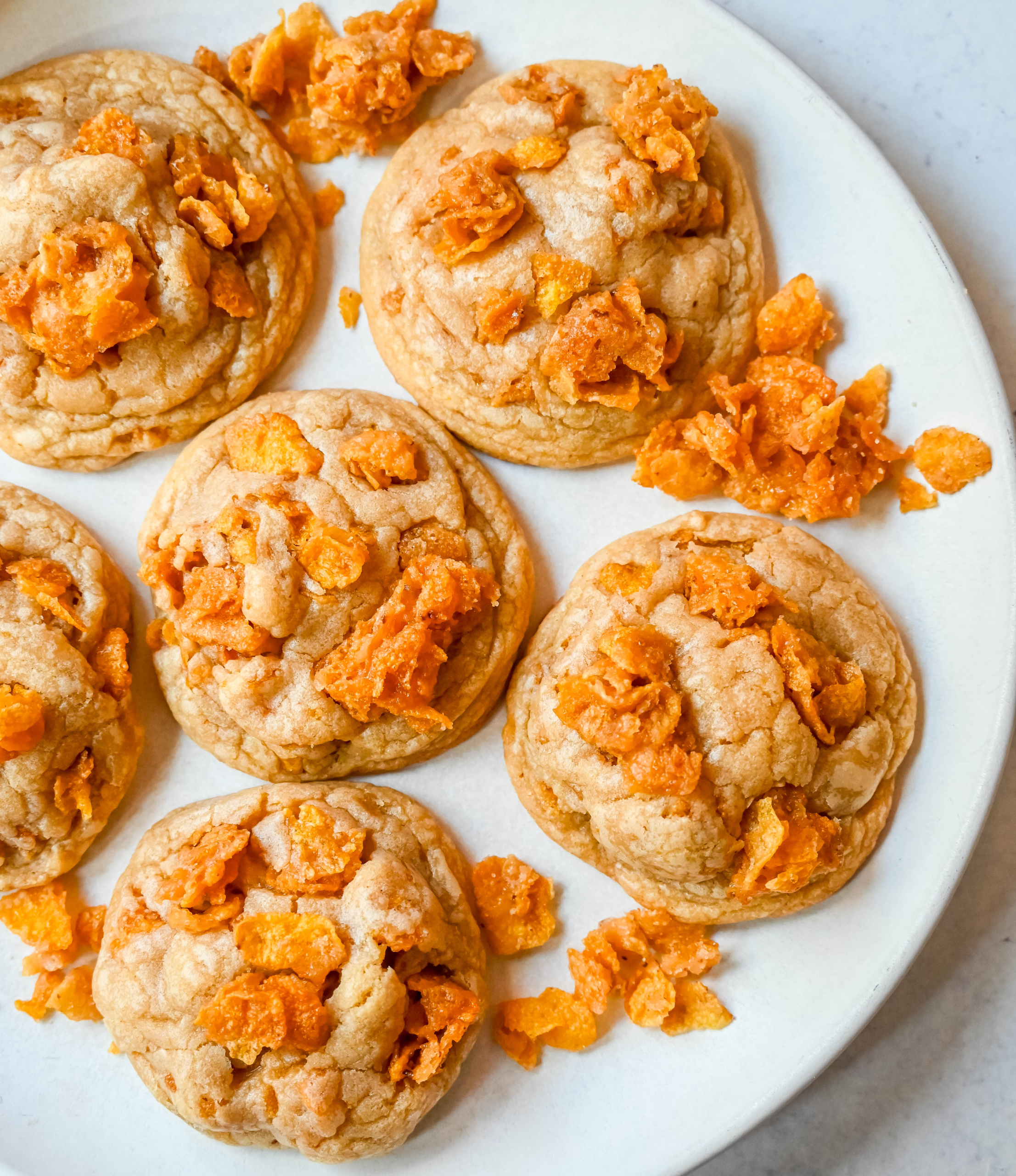 These Cornflake Crack Cookies are buttery, chewy, crispy cookies with toffee caramel notes thanks to homemade cornflake crack in and on top of the cookies. These sweet and salty cookies are always a hit!