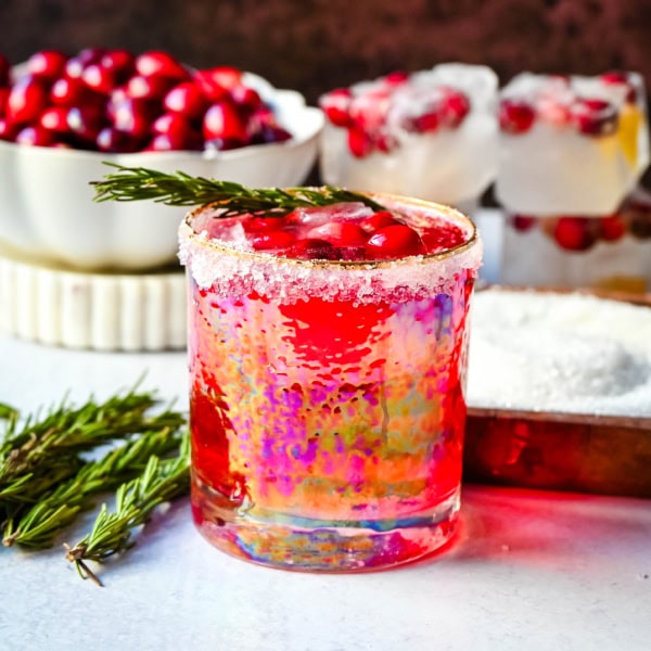 A cranberry mocktail is a gorgeous, tart, and refreshing beverage that pairs beautifully with cozy winter evenings or holiday parties. Cranberry juice, cranberry sprite, and cranberry orange infused ice cubes all in a sugar rimmed glass make this an extra special holiday mocktail recipe.