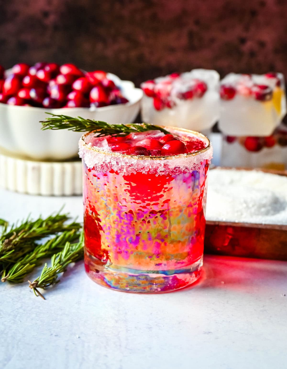 A cranberry mocktail is a gorgeous, tart, and refreshing beverage that pairs beautifully with cozy winter evenings or holiday parties. Cranberry juice, cranberry sprite, and cranberry orange infused ice cubes all in a sugar rimmed glass make this an extra special holiday mocktail recipe.