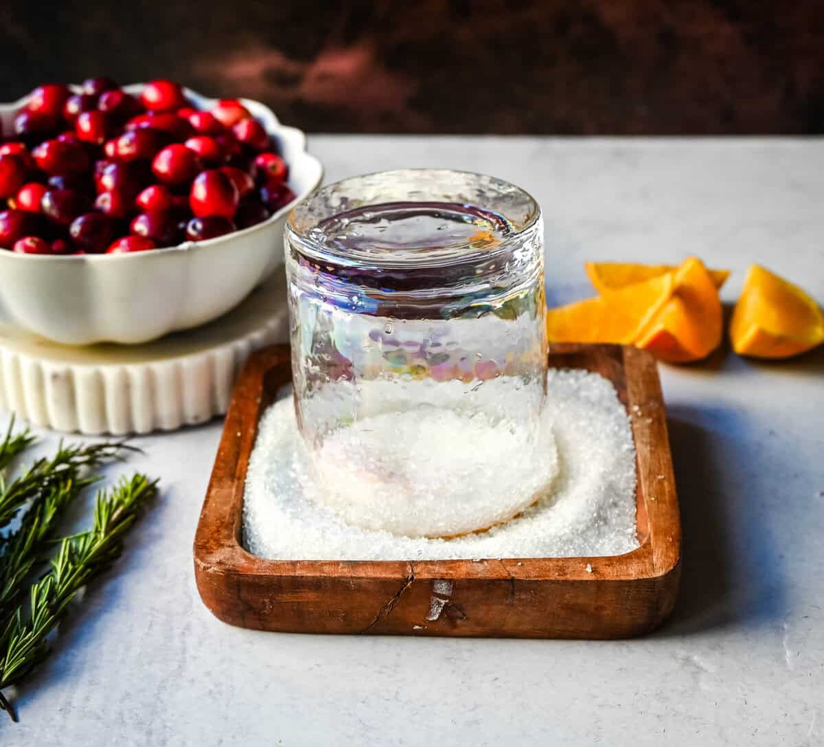 Dipping glass in sugar to make a sugar rim.