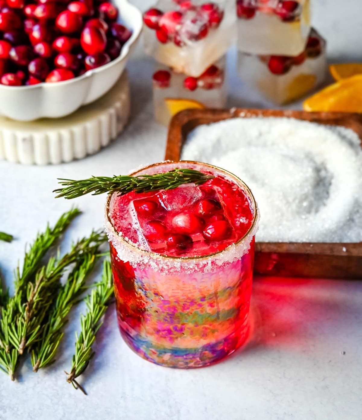 A cranberry mocktail is a gorgeous, tart, and refreshing beverage that pairs beautifully with cozy winter evenings or holiday parties. Cranberry juice, cranberry sprite, and cranberry orange infused ice cubes all in a sugar rimmed glass make this an extra special holiday mocktail recipe.