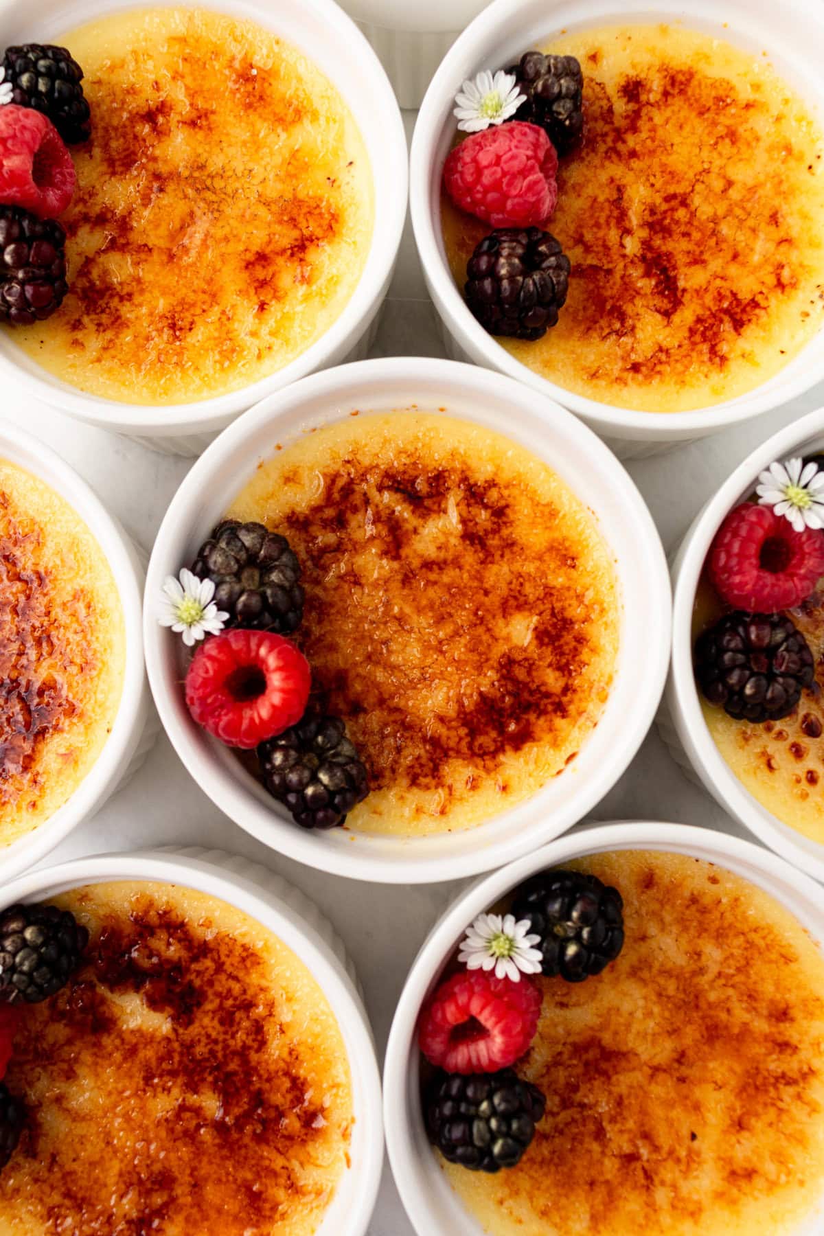 Creme Brulee in ramekins. A creamy, silky vanilla custard topped with crisp sugar crust is one of the most popular desserts at restaurants for good reason. With its silky custard base and crackly caramelized sugar topping, it’s a showstopper that’s surprisingly easy to make at home. 