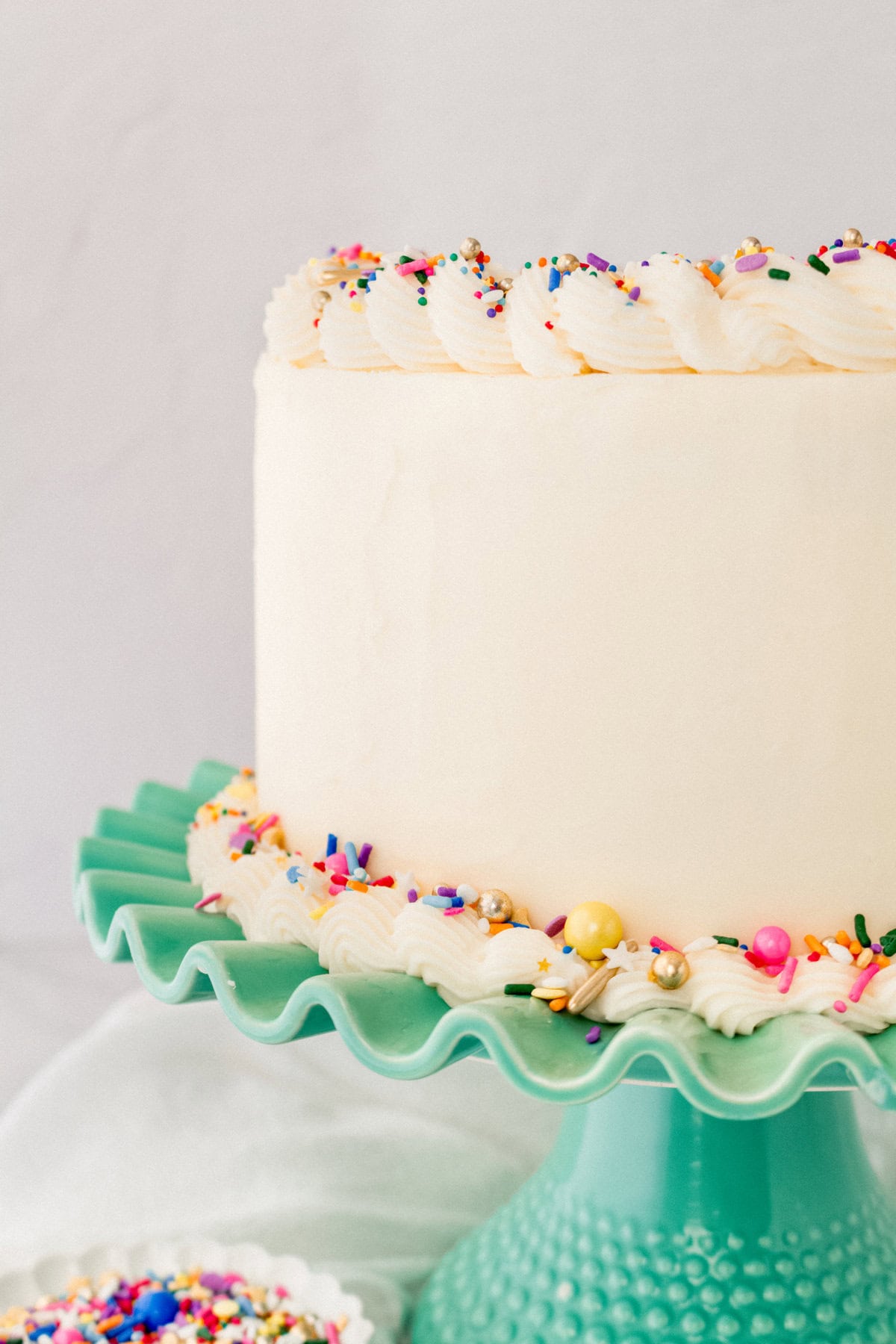 A layered funfetti or confetti cake with sprinkles. A fluffy homemade Funfetti birthday cake with rainbow sprinkles topped with a light cream cheese buttercream frosting and an array of sprinkles. This Confetti Cake recipe is the perfect birthday cake!