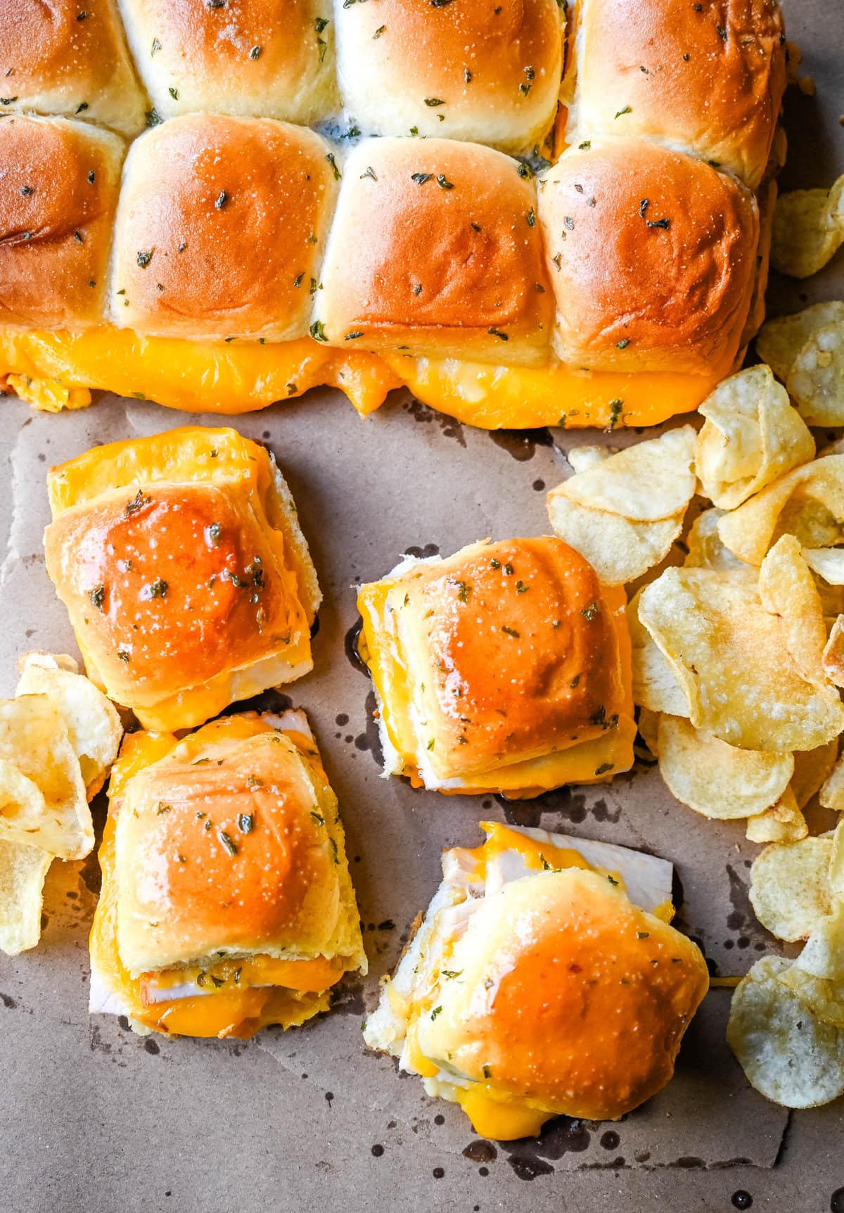 Garlic Herb Turkey and Cheddar Sliders. These Baked Turkey and Cheddar Sliders on Hawaiian Rolls with a sweet honey mustard spread and homemade garlic butter brushed on top are the perfect turkey slider recipe.  