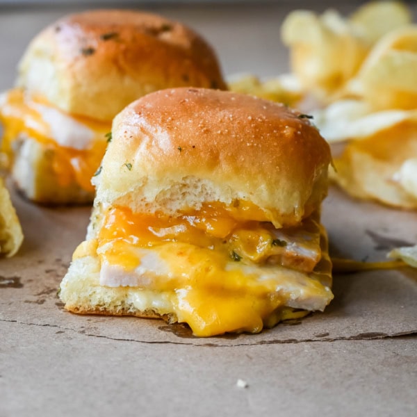 Garlic Herb Turkey and Cheddar Sliders. These Baked Turkey and Cheddar Sliders on Hawaiian Rolls with a sweet honey mustard spread and homemade garlic butter brushed on top are the perfect turkey slider recipe.