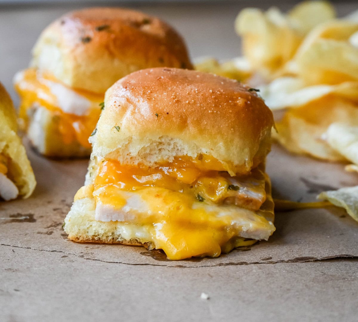 Garlic Herb Turkey and Cheddar Sliders. These Baked Turkey and Cheddar Sliders on Hawaiian Rolls with a sweet honey mustard spread and homemade garlic butter brushed on top are the perfect turkey slider recipe.  