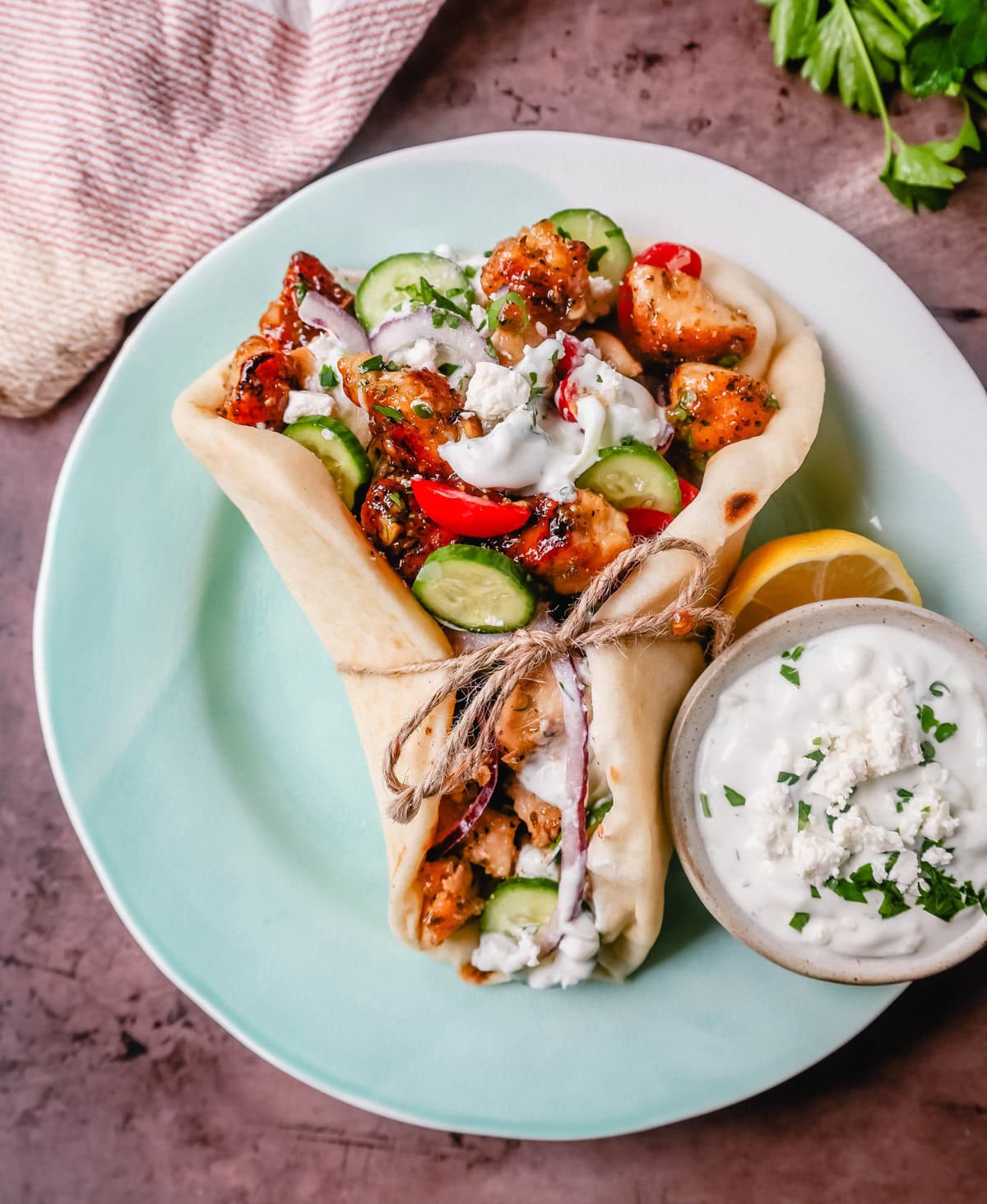 Greek Chicken Gyros with homemade tzatziki sauce. If you’re craving the vibrant flavors of the Mediterranean, chicken gyros with tzatziki sauce are the perfect choice. Tender, seasoned chicken, tangy tzatziki sauce, fresh greek salad, and soft, pillowy pita bread pair perfectly together. This is such a popular dinner recipe!