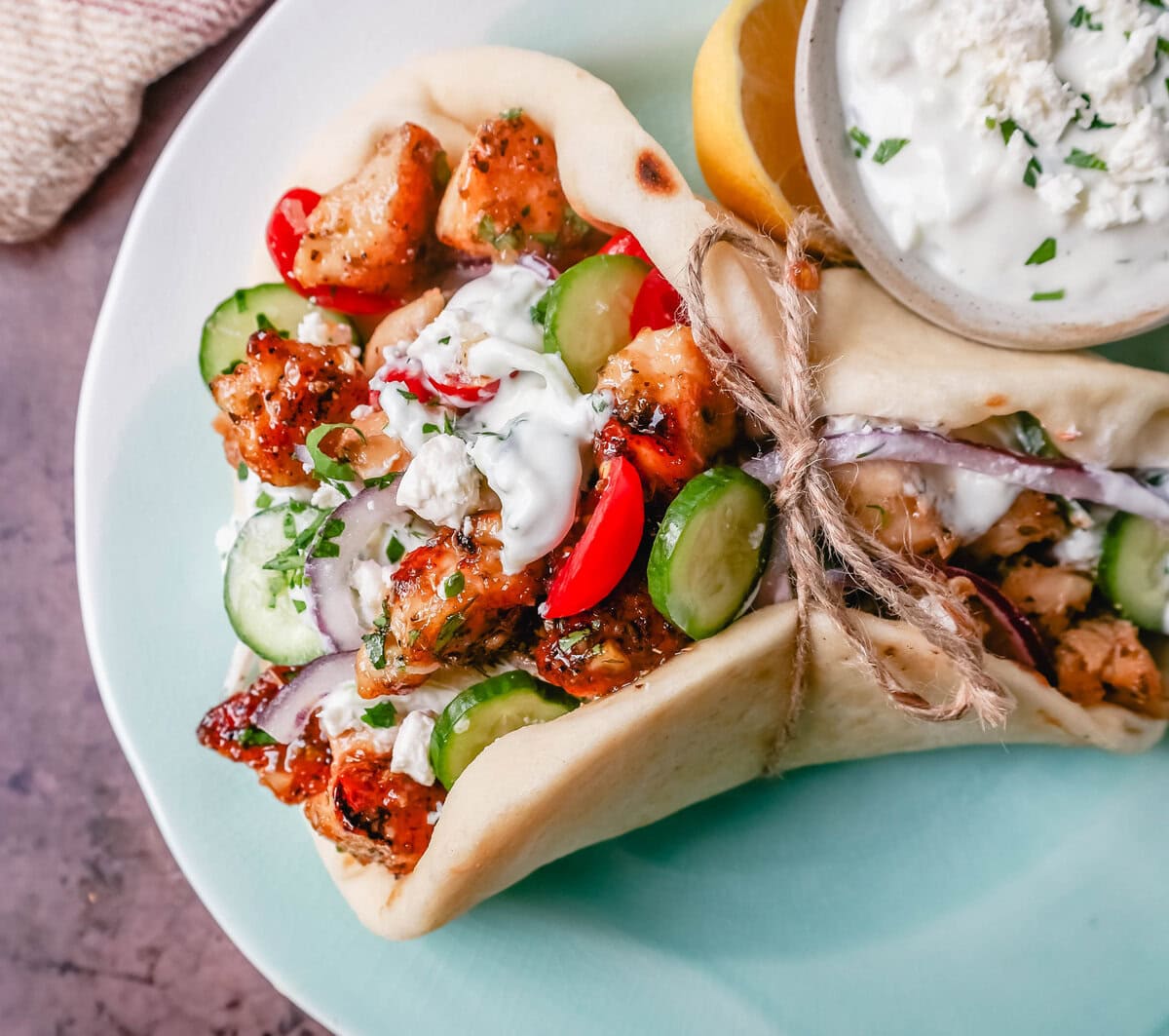 Greek Chicken Gyros with homemade tzatziki sauce. If you’re craving the vibrant flavors of the Mediterranean, chicken gyros with tzatziki sauce are the perfect choice. Tender, seasoned chicken, tangy tzatziki sauce, fresh greek salad, and soft, pillowy pita bread pair perfectly together. This is such a popular dinner recipe!