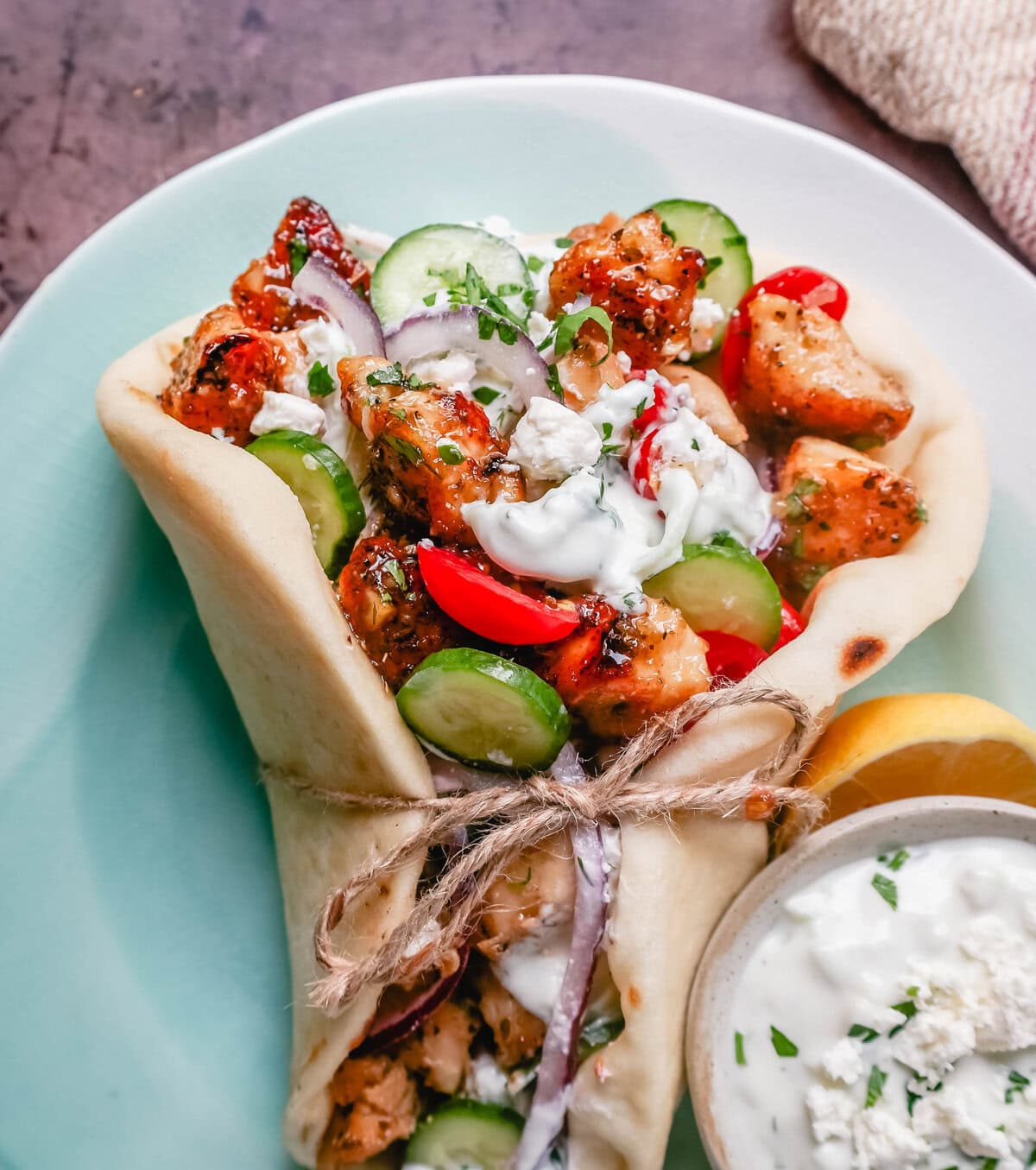 Greek Chicken Gyros with homemade tzatziki sauce. If you’re craving the vibrant flavors of the Mediterranean, chicken gyros with tzatziki sauce are the perfect choice. Tender, seasoned chicken, tangy tzatziki sauce, fresh greek salad, and soft, pillowy pita bread pair perfectly together. This is such a popular dinner recipe!