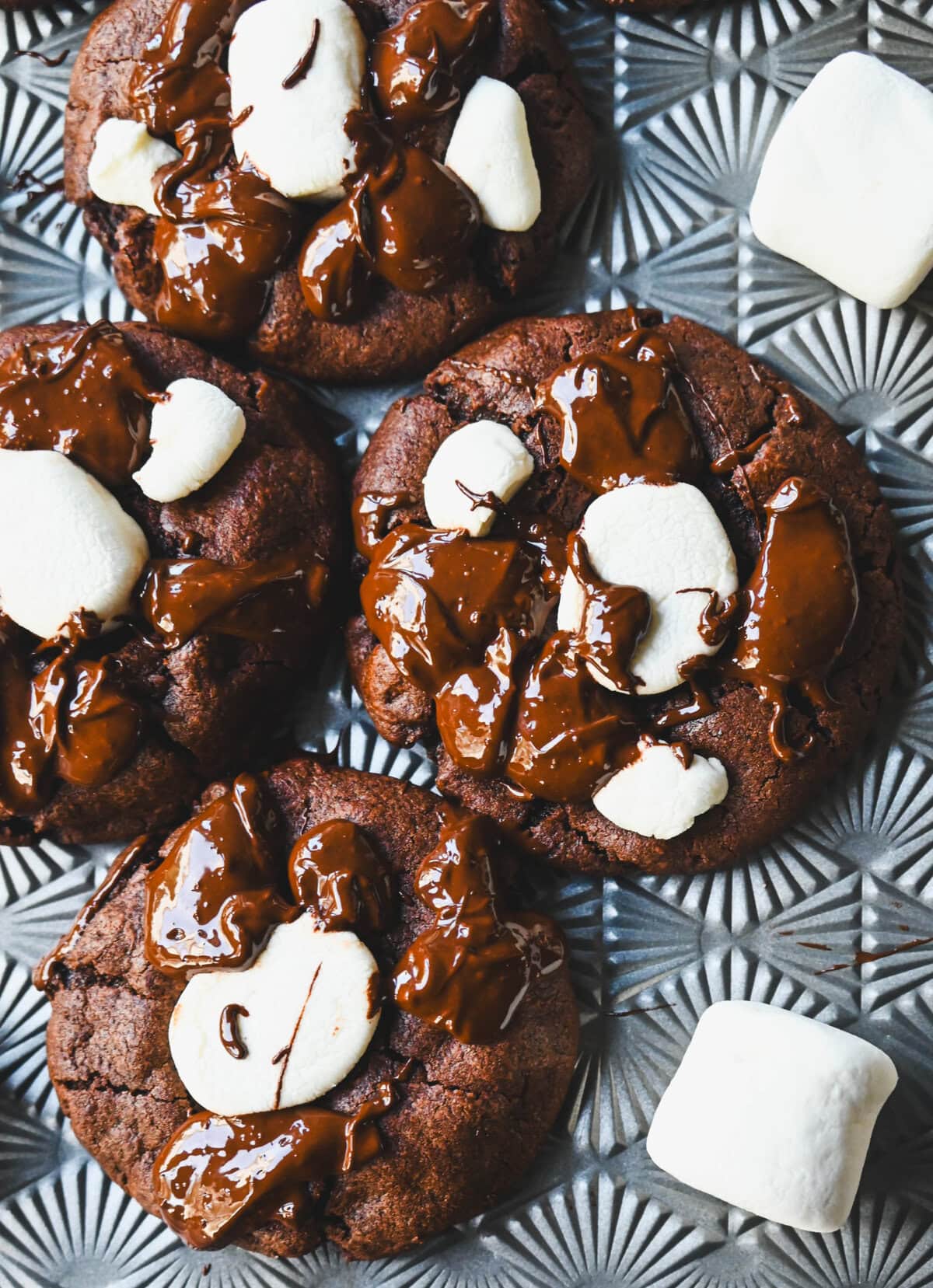 These Hot Cocoa Cookies feature a homemade chocolate cookie base, a gooey marshmallow topping, and a drizzle of melted chocolate for the perfect finishing touch. If you love peppermint, add crushed candy canes and a hint of peppermint extract for Peppermint Hot Cocoa Cookies.