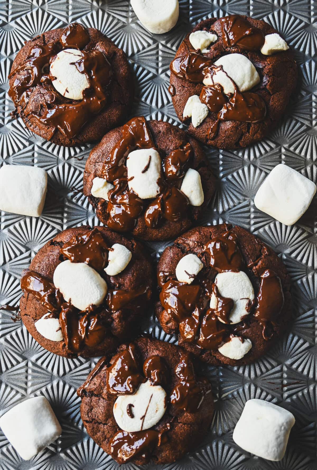 These Hot Cocoa Cookies feature a homemade chocolate cookie base, a gooey marshmallow topping, and a drizzle of melted chocolate for the perfect finishing touch. If you love peppermint, add crushed candy canes and a hint of peppermint extract for Peppermint Hot Cocoa Cookies.