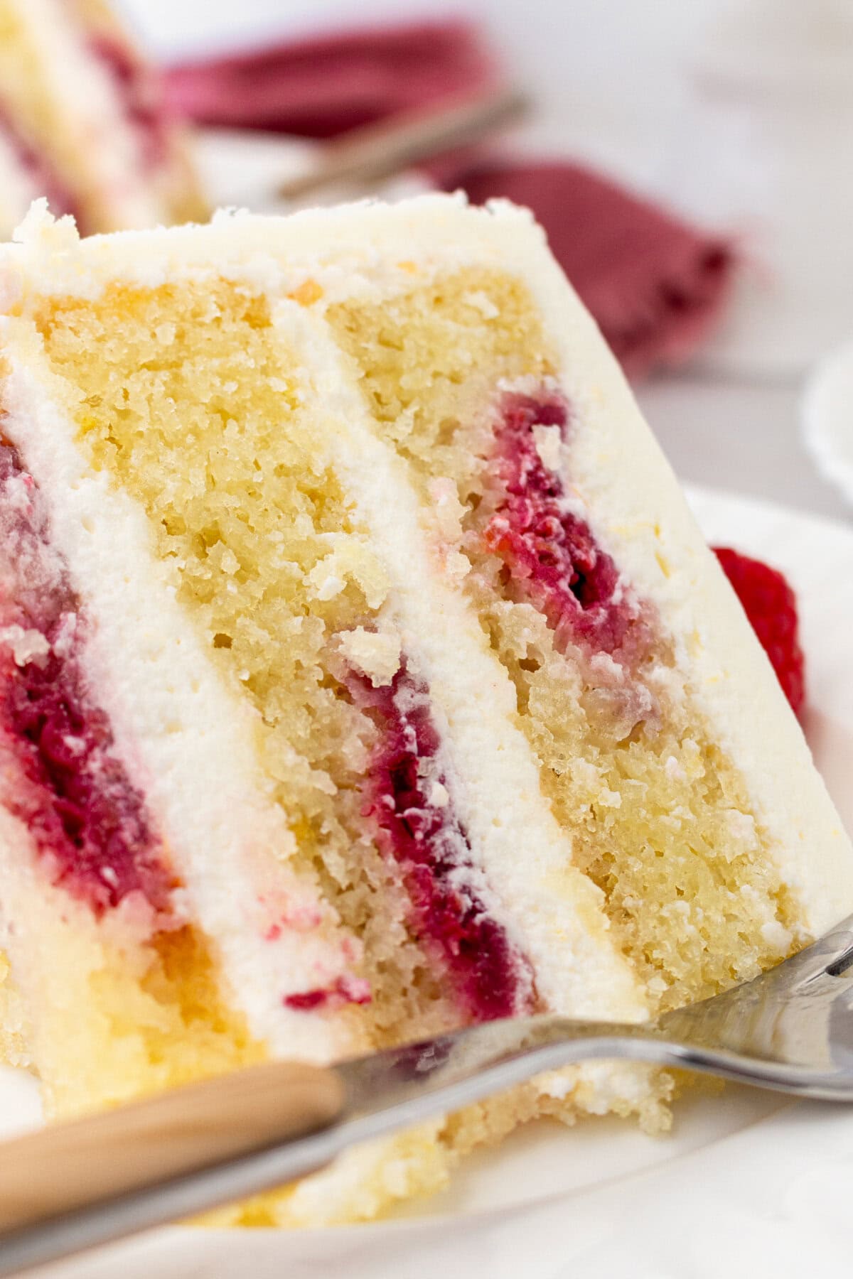 Lemon Raspberry Cake with Lemon Cream Cheese Frosting. A light and fluffy lemon cake with fresh raspberries and a fresh lemon cream cheese frosting. A sweet and tangy lemon berry cake!