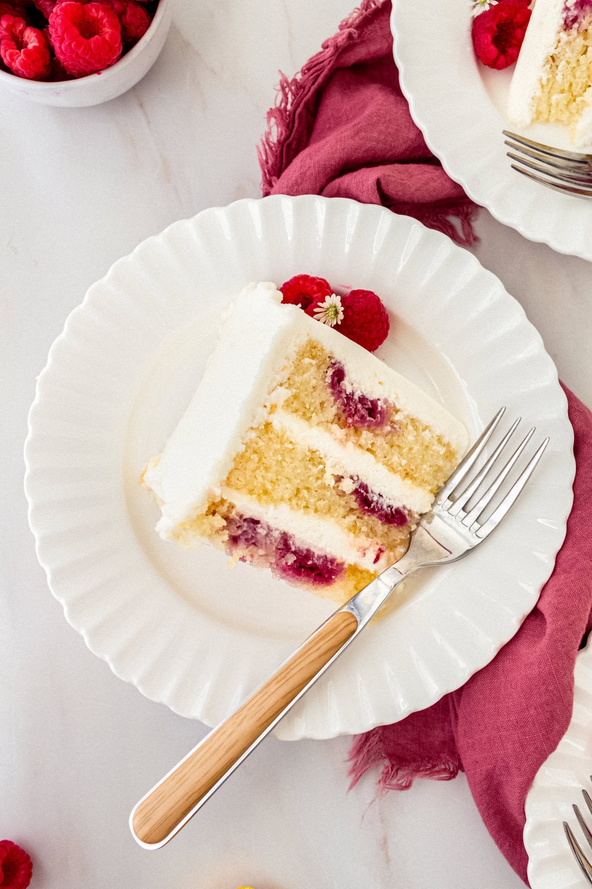 Lemon Raspberry Cake with Lemon Cream Cheese Frosting. A light and fluffy lemon cake with fresh raspberries and a fresh lemon cream cheese frosting. A sweet and tangy lemon berry cake!