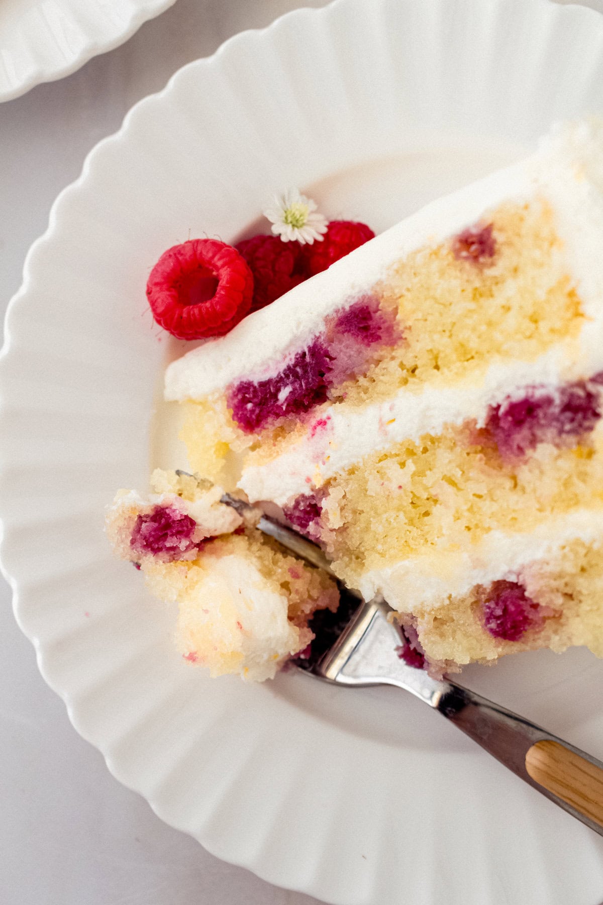 Lemon Raspberry Cake with Lemon Cream Cheese Frosting. A light and fluffy lemon cake with fresh raspberries and a fresh lemon cream cheese frosting. A sweet and tangy lemon berry cake!