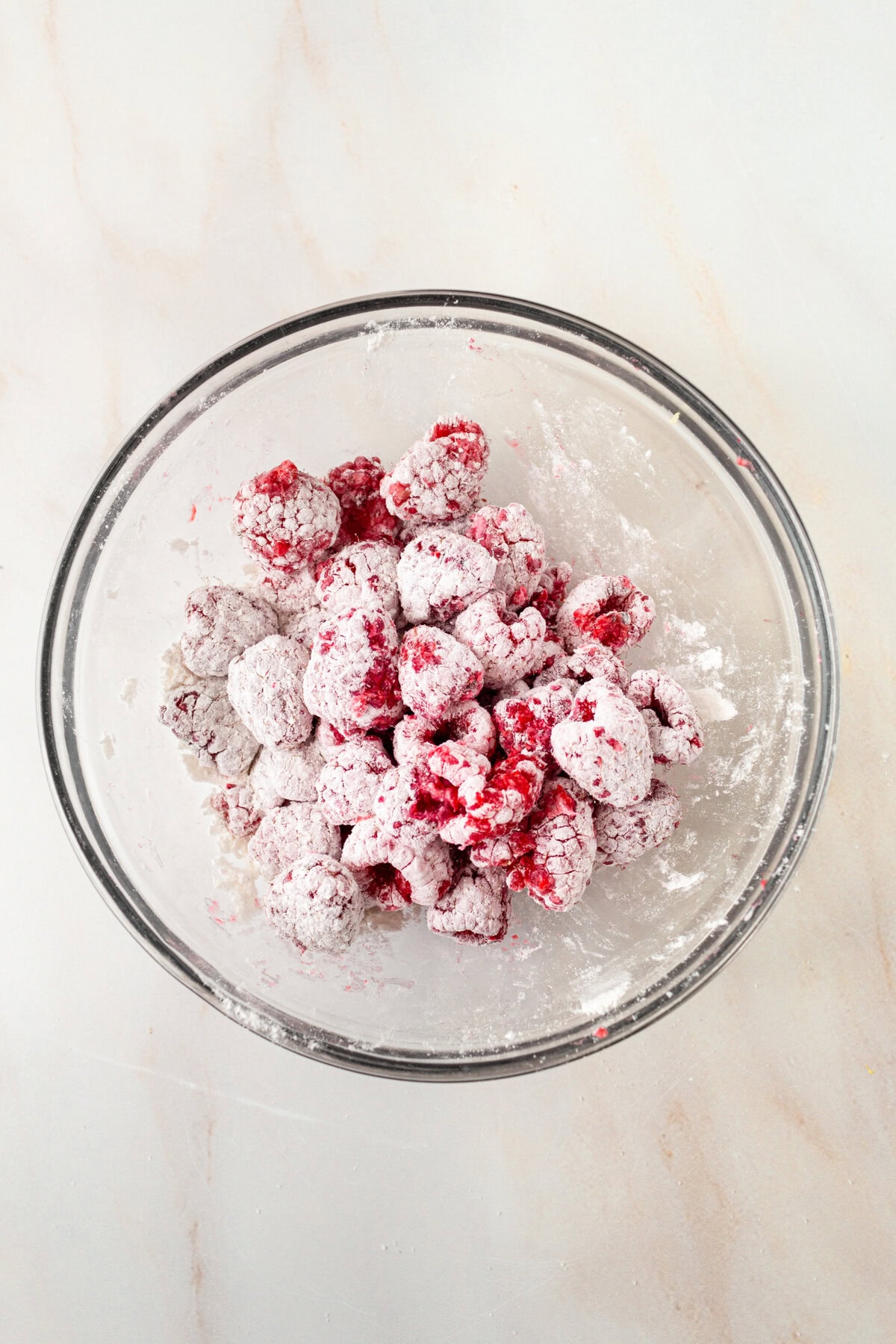 Coat raspberries with flour to keep from sinking to the bottom of the cake