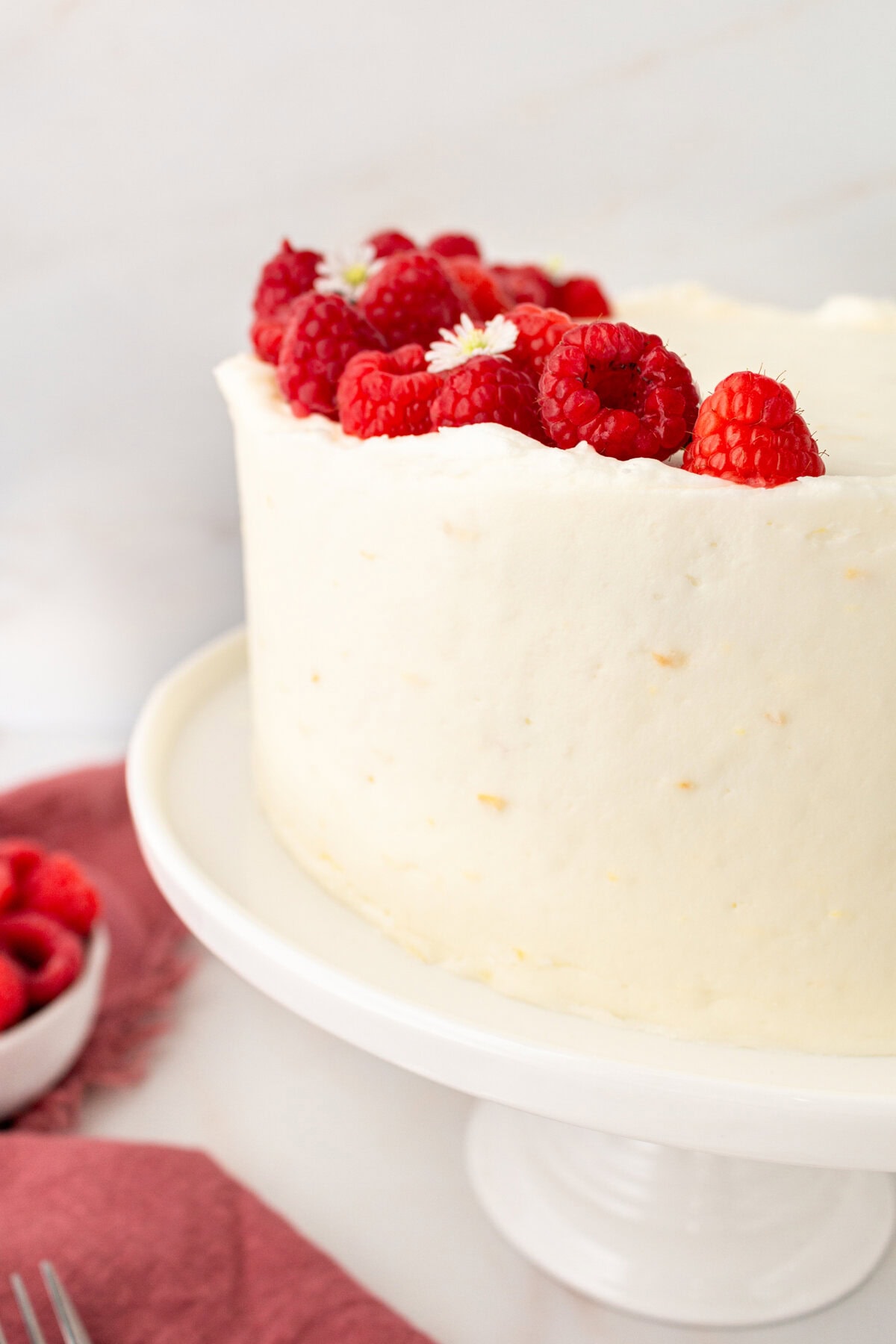 Lemon Raspberry Cake with Lemon Cream Cheese Frosting. A light and fluffy lemon cake with fresh raspberries and a fresh lemon cream cheese frosting. A sweet and tangy lemon berry cake!