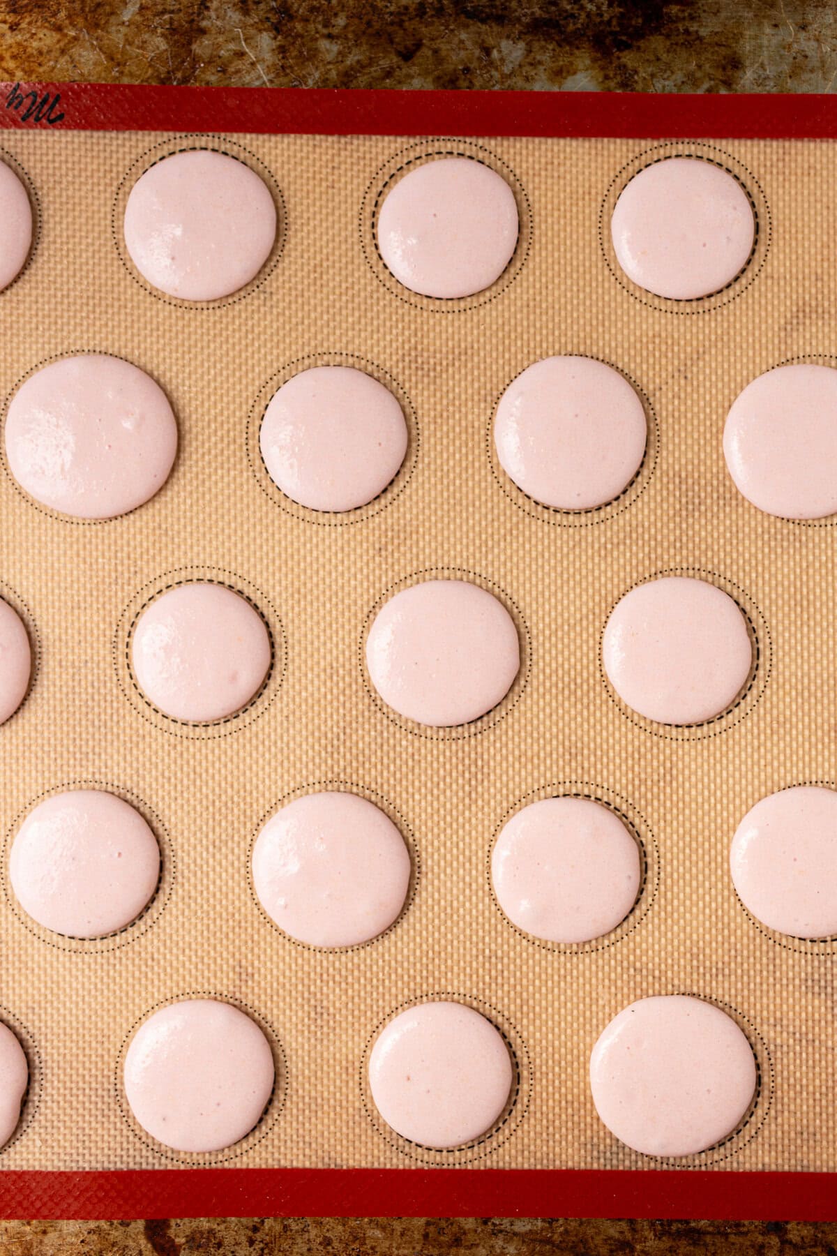 How to make homemade macarons. How to pipe the macarons onto a baking sheet.