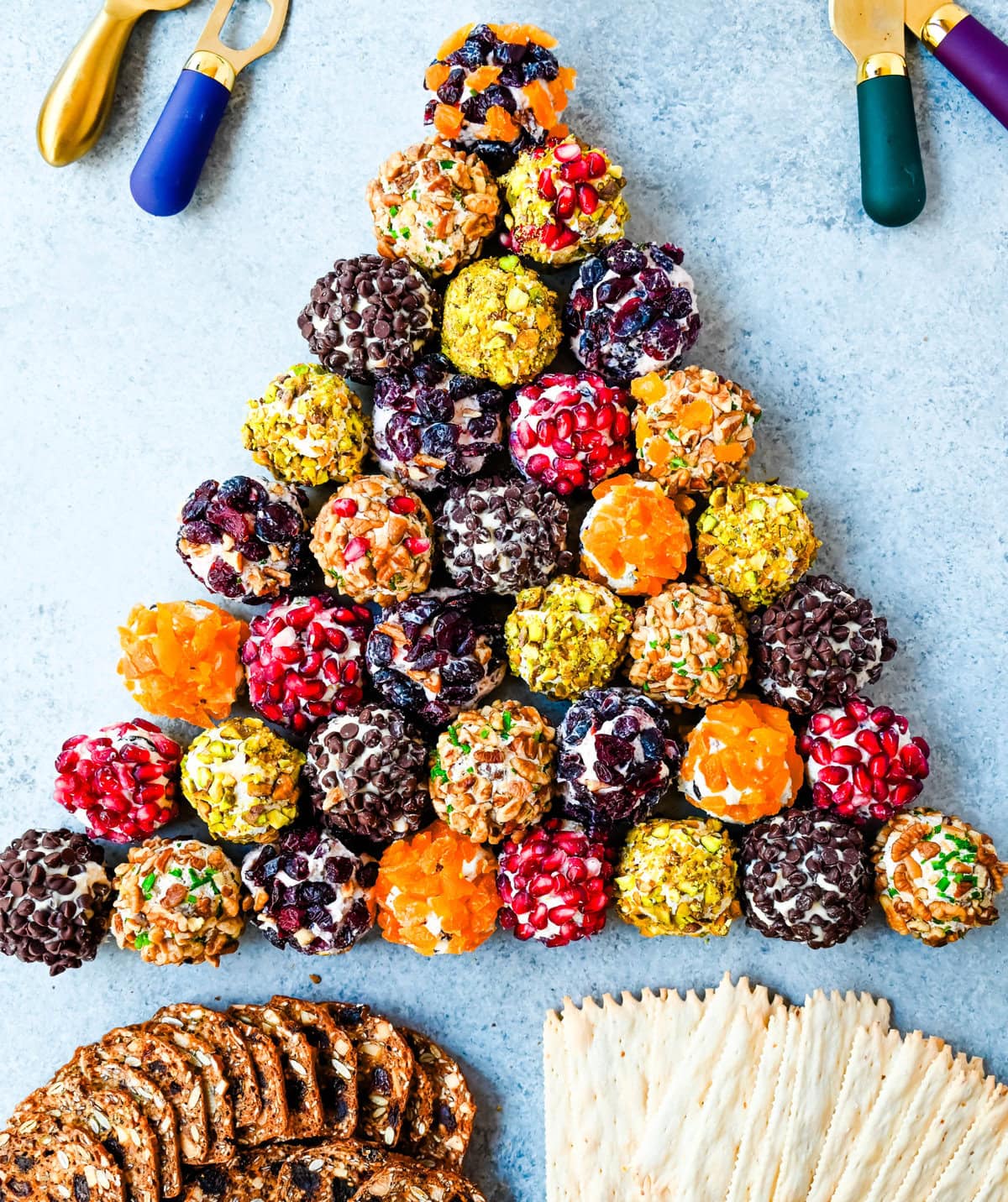 Mini Cheese Balls are the ultimate crowd-pleasing appetizer—bite-sized, creamy, and endlessly customizable. Whether you're hosting a party, creating a stunning charcuterie board, or need a quick snack for guests, these cheese ball bites will be a hit! With options ranging from savory herbs and spices to sweet fruity toppings, there are so many combinations to try. I am also sharing how to make a cheese ball Christmas tree and cheese ball Christmas wreath for a holiday appetizer idea.