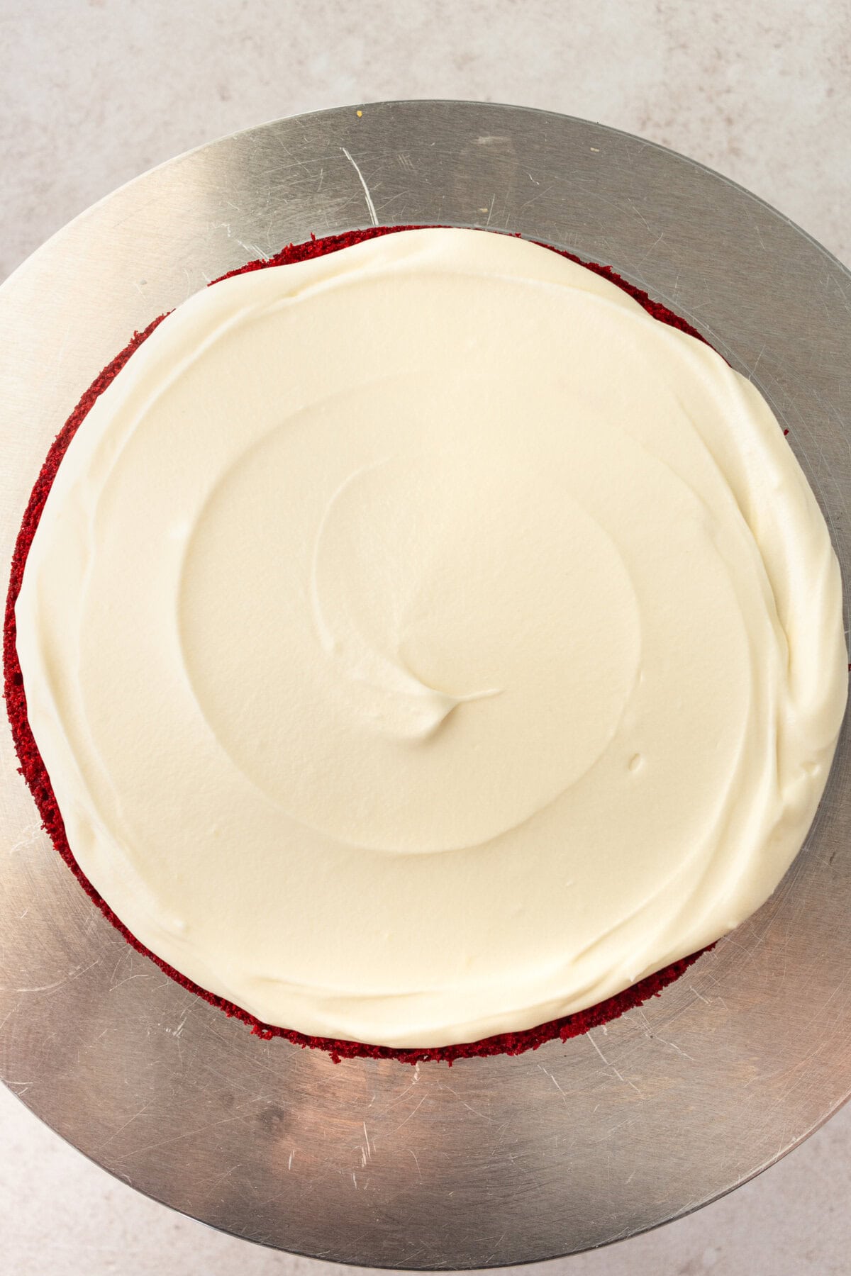 Frosting a red velvet layer cake