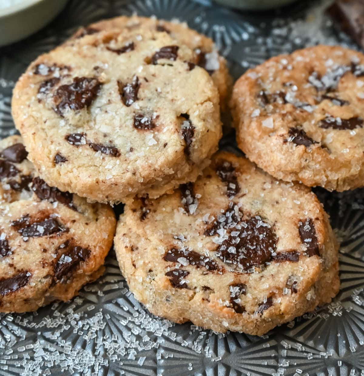 Salted chocolate chunk shortbread cookies are a twist on the classic chocolate chunk cookie, combining buttery, crumbly shortbread with rich chocolate chunks and a hint of flaky sea salt. These chocolate chip shortbread cookies are a perfect balance of sweet, salty, and savory flavors with a melt-in-your-mouth texture.