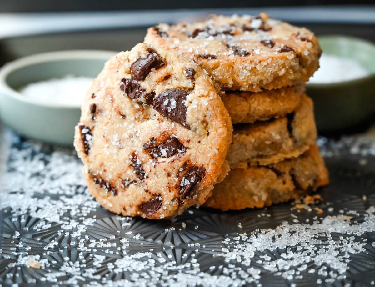 Salted chocolate chunk shortbread cookies are a twist on the classic chocolate chunk cookie, combining buttery, crumbly shortbread with rich chocolate chunks and a hint of flaky sea salt. These chocolate chip shortbread cookies are a perfect balance of sweet, salty, and savory flavors with a melt-in-your-mouth texture.