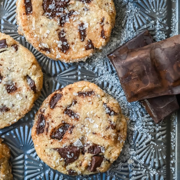 Salted chocolate chunk shortbread cookies are a twist on the classic chocolate chunk cookie, combining buttery, crumbly shortbread with rich chocolate chunks and a hint of flaky sea salt. These chocolate chip shortbread cookies are a perfect balance of sweet, salty, and savory flavors with a melt-in-your-mouth texture.