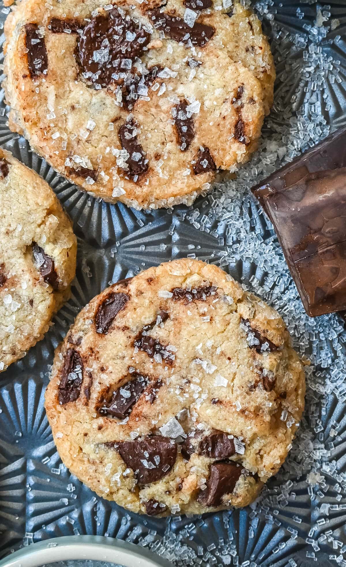 Salted chocolate chunk shortbread cookies are a twist on the classic chocolate chunk cookie, combining buttery, crumbly shortbread with rich chocolate chunks and a hint of flaky sea salt. These chocolate chip shortbread cookies are a perfect balance of sweet, salty, and savory flavors with a melt-in-your-mouth texture.