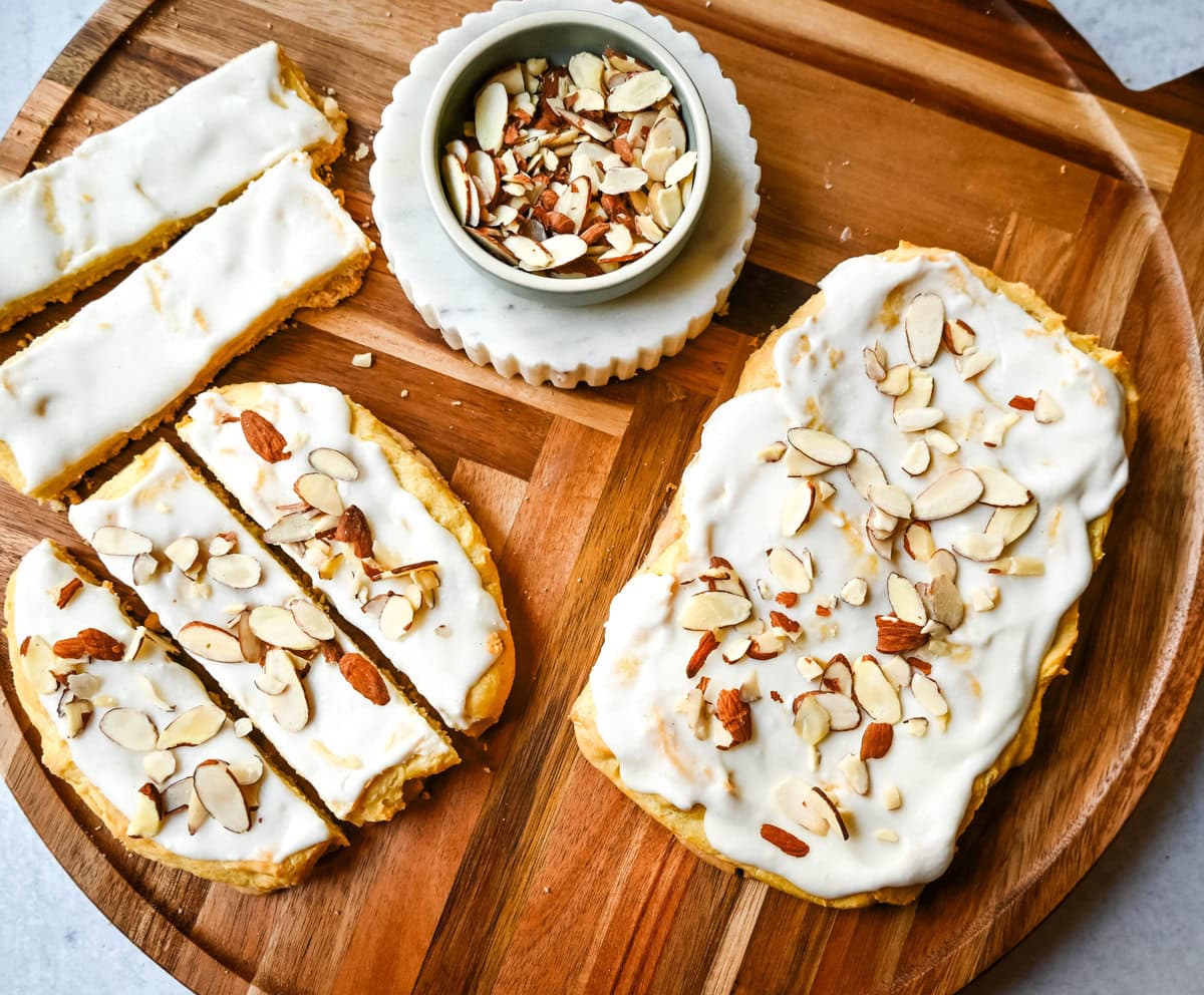 This homemade Swedish Pastry, also known as Danish Kringle, features a buttery crust, an almond filling, and topped with an almond frosting. This buttery pastry is buttery, creamy, and has just the right sweetness. A holiday tradition!