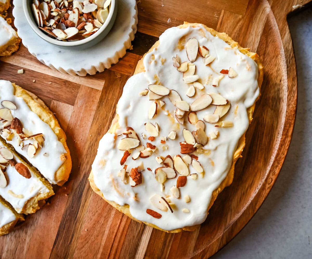 This homemade Swedish Pastry, also known as Danish Kringle, features a buttery crust, an almond filling, and topped with an almond frosting. This buttery pastry is buttery, creamy, and has just the right sweetness. A holiday tradition!