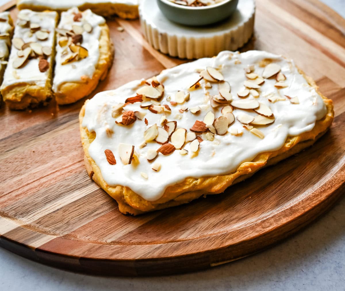 This homemade Swedish Pastry, also known as Danish Kringle, features a buttery crust, an almond filling, and topped with an almond frosting. This buttery pastry is buttery, creamy, and has just the right sweetness. A holiday tradition!