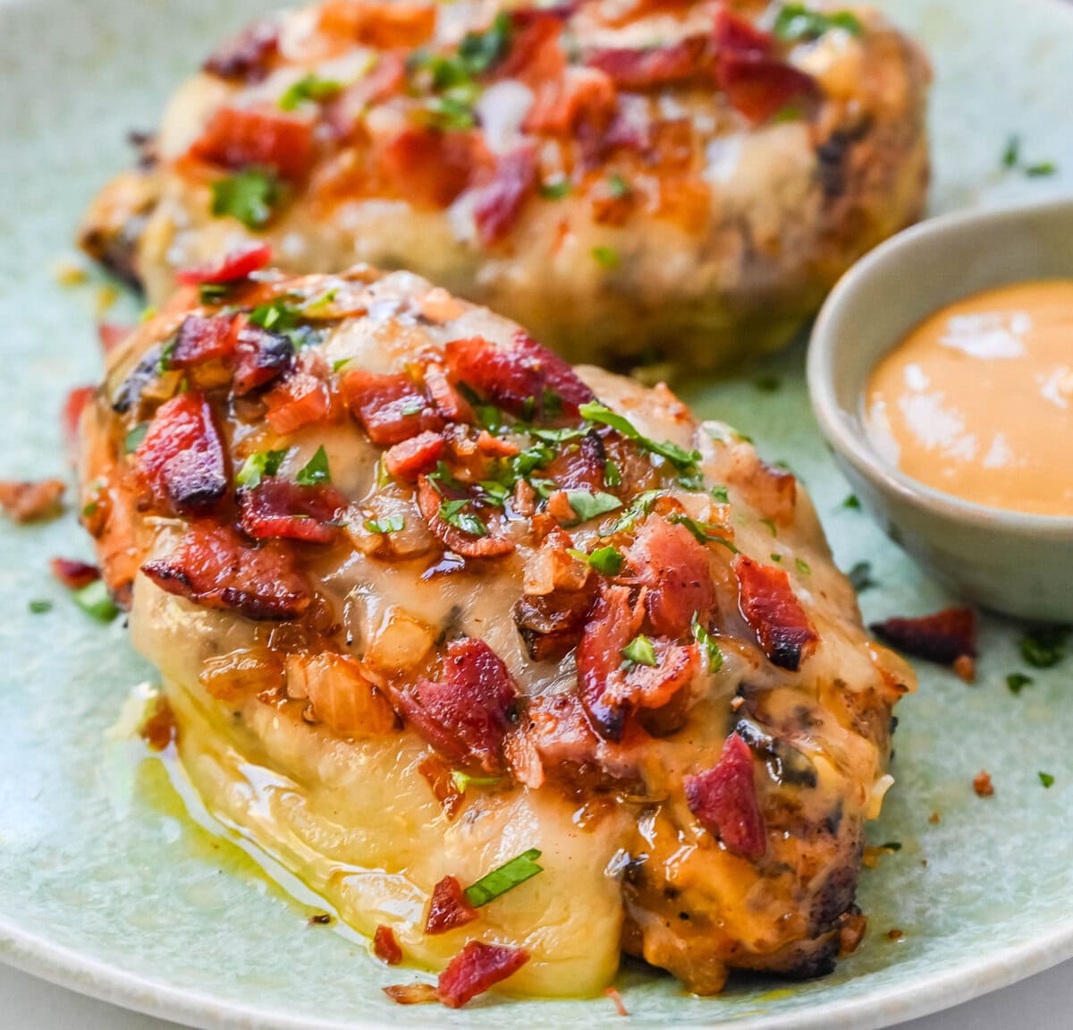 Cheesy Bacon Smothered Chicken. This juicy, marinated grilled chicken breast is smothered with honey mustard sauce, melted cheese, and crispy bacon. To make it extra flavorful, add caramelized onions or mushrooms. You may know this as the famous Alice Springs Chicken from Outback Steakhouse but you can make it at home. 