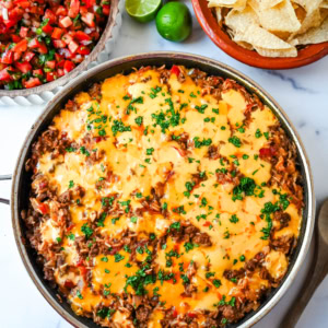 This Cheesy Taco Rice Skillet is a hearty, one-pan meal that brings all your favorite Tex-Mex flavors together in under 30 minutes. This Mexican Taco Skillet is loaded with seasoned ground beef, uncooked rice, and diced tomatoes—then simmered in a savory blend of beef broth and spices until perfectly tender and topped with melted cheese. A total crowd-pleaser for families and busy weeknights.