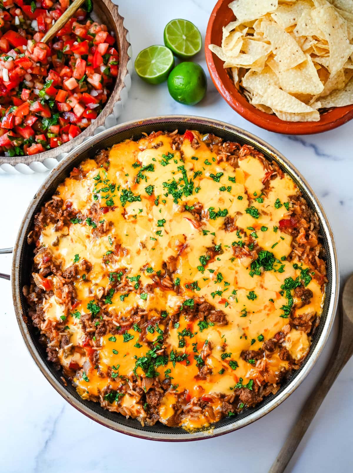 This Cheesy Taco Rice Skillet is a hearty, one-pan meal that brings all your favorite Tex-Mex flavors together in under 30 minutes. This Mexican Taco Skillet is loaded with seasoned ground beef, uncooked rice, and diced tomatoes—then simmered in a savory blend of beef broth and spices until perfectly tender and topped with melted cheese. A total crowd-pleaser for families and busy weeknights.  