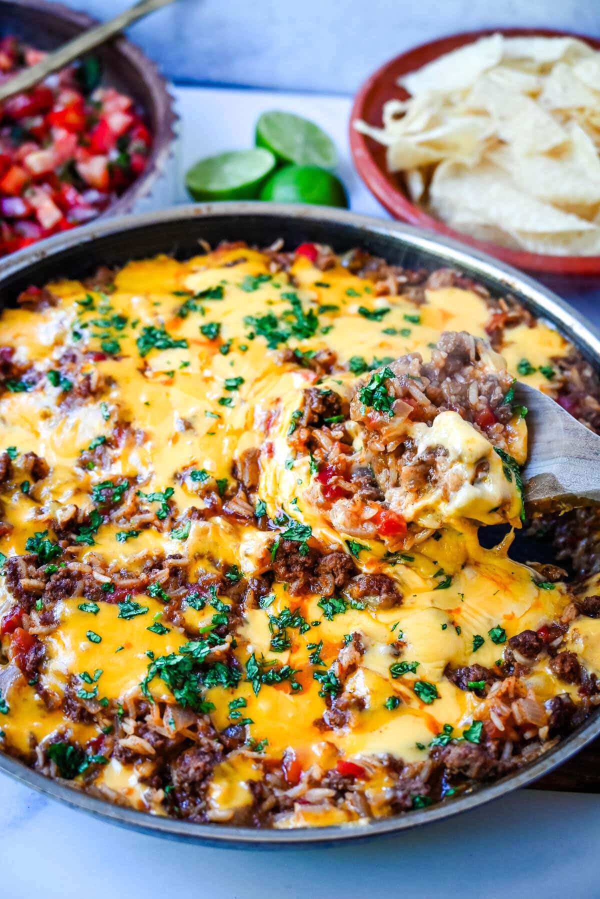 This Cheesy Taco Rice Skillet is a hearty, one-pan meal that brings all your favorite Tex-Mex flavors together in under 30 minutes. This Mexican Taco Skillet is loaded with seasoned ground beef, uncooked rice, and diced tomatoes—then simmered in a savory blend of beef broth and spices until perfectly tender and topped with melted cheese. A total crowd-pleaser for families and busy weeknights.  