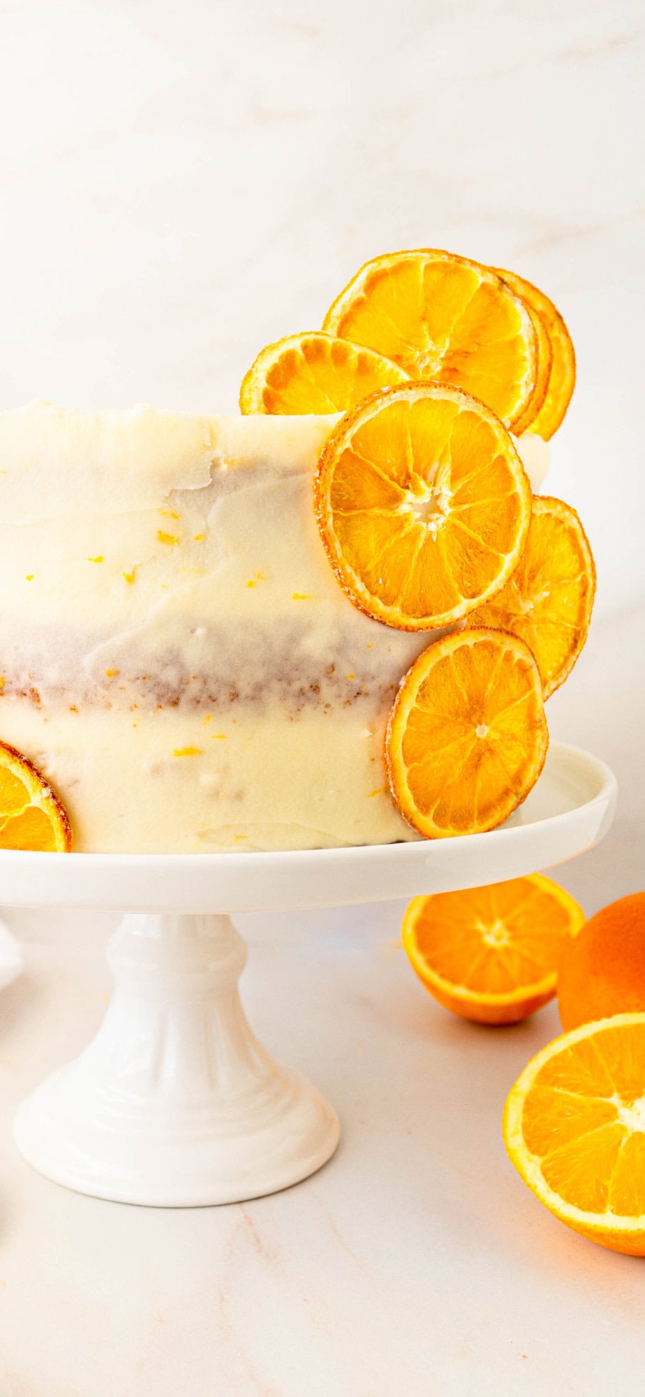 A moist, tender fresh orange cake with a sweet orange cream cheese frosting. This homemade orange cake that is bursting with bright citrus flavor in every bite. Each layer is moist, fluffy, and perfectly enhanced by an orange cream cheese frosting. The fresh orange juice and zest adds fresh orange flavor. Here are tips for making the perfect frosted orange cake! This can also be made into an orange naked cake.