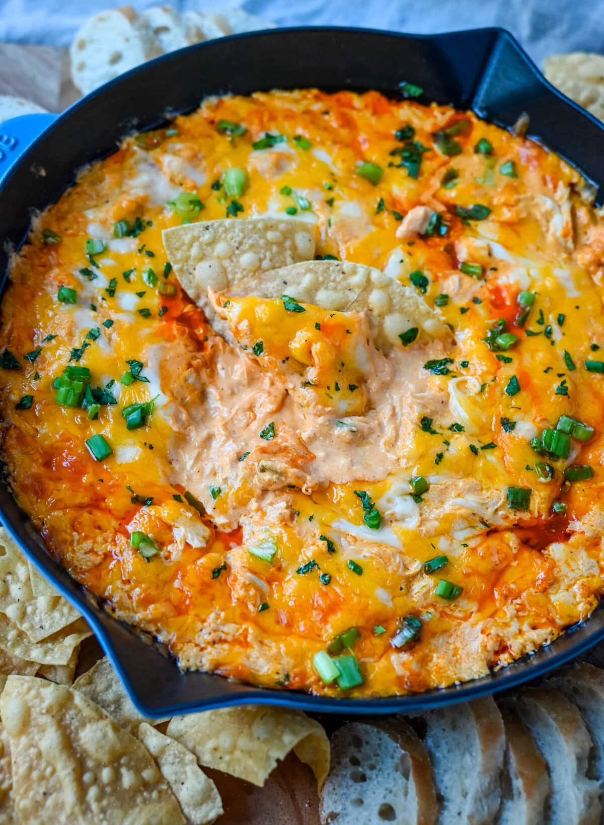 This Hot Creamy Buffalo Chip Dip is made with tender shredded chicken, cream cheese, buffalo sauce, ranch dressing, and topped with cheese, and baked until warm and bubbly. This is a perfect Super Bowl appetizer and this Chicken Hot Wing Dip is always a hit!