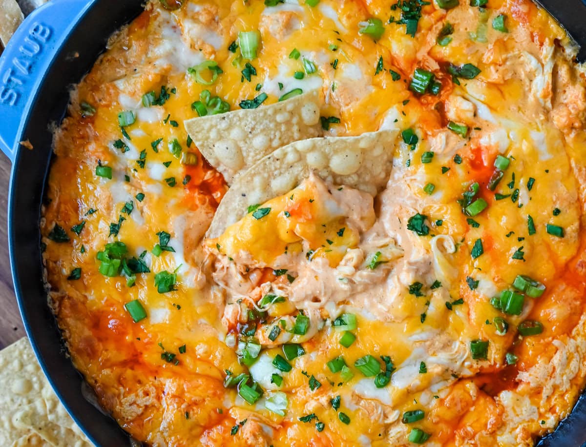 This Hot Creamy Buffalo Chip Dip is made with tender shredded chicken, cream cheese, buffalo sauce, ranch dressing, and topped with cheese, and baked until warm and bubbly. This is a perfect Super Bowl appetizer and this Chicken Hot Wing Dip is always a hit!