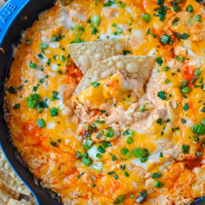 This Hot Creamy Buffalo Chip Dip is made with tender shredded chicken, cream cheese, buffalo sauce, ranch dressing, and topped with cheese, and baked until warm and bubbly. This is a perfect Super Bowl appetizer and this Chicken Hot Wing Dip is always a hit!