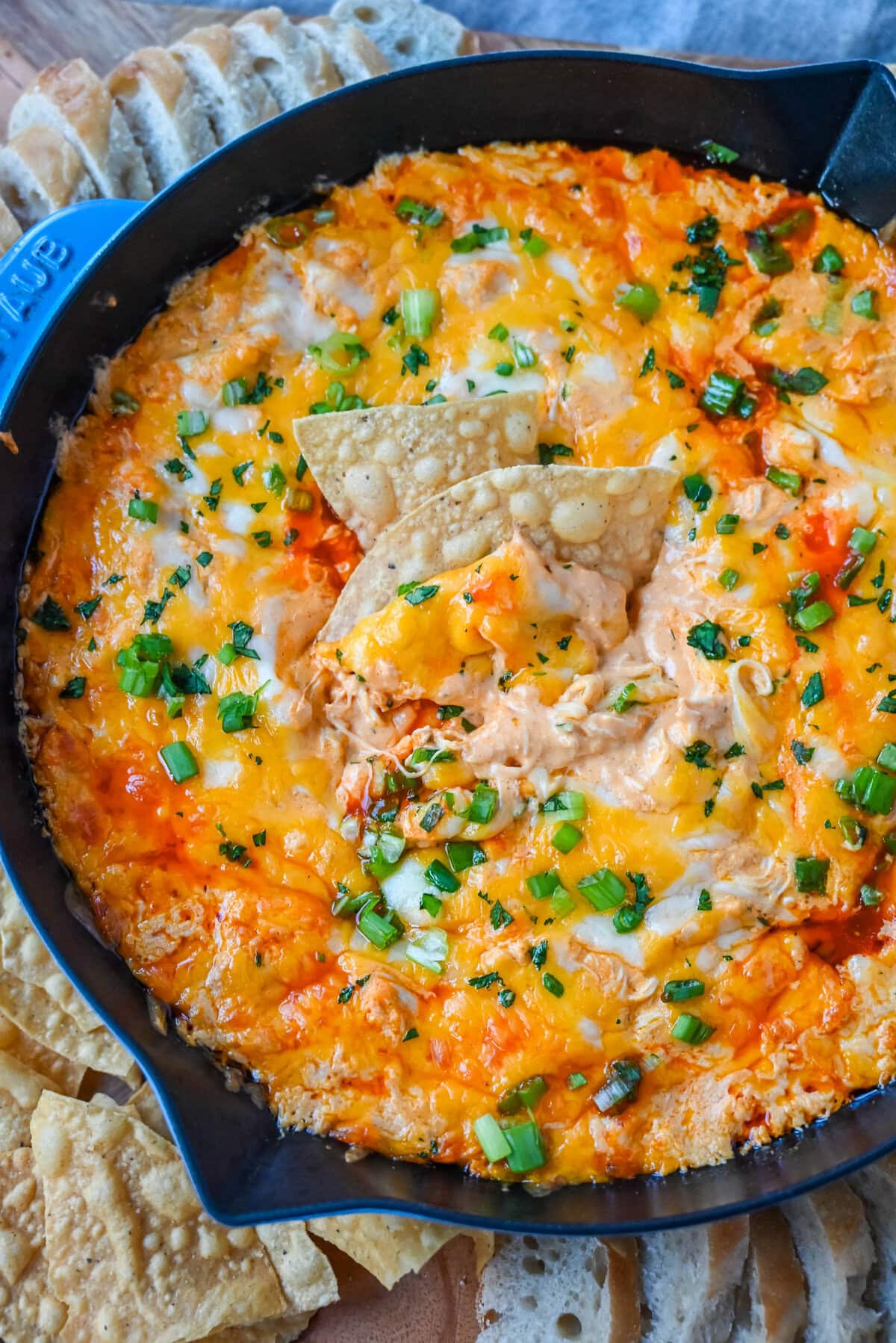 This Hot Creamy Buffalo Chip Dip is made with tender shredded chicken, cream cheese, buffalo sauce, ranch dressing, and topped with cheese, and baked until warm and bubbly. This is a perfect Super Bowl appetizer and this Chicken Hot Wing Dip is always a hit!